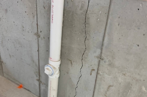 vertical crack next to main pipe