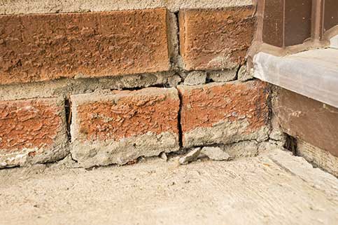 Cracked brick next to home doorway