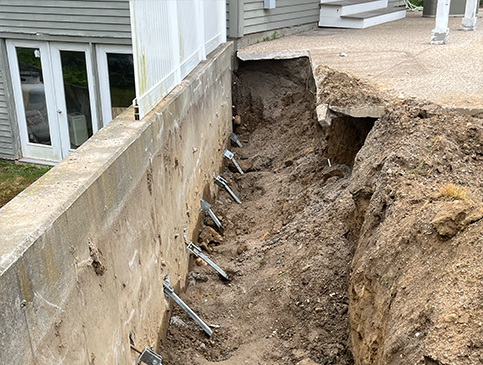 ground dug out next to retaining wall in rhode islande